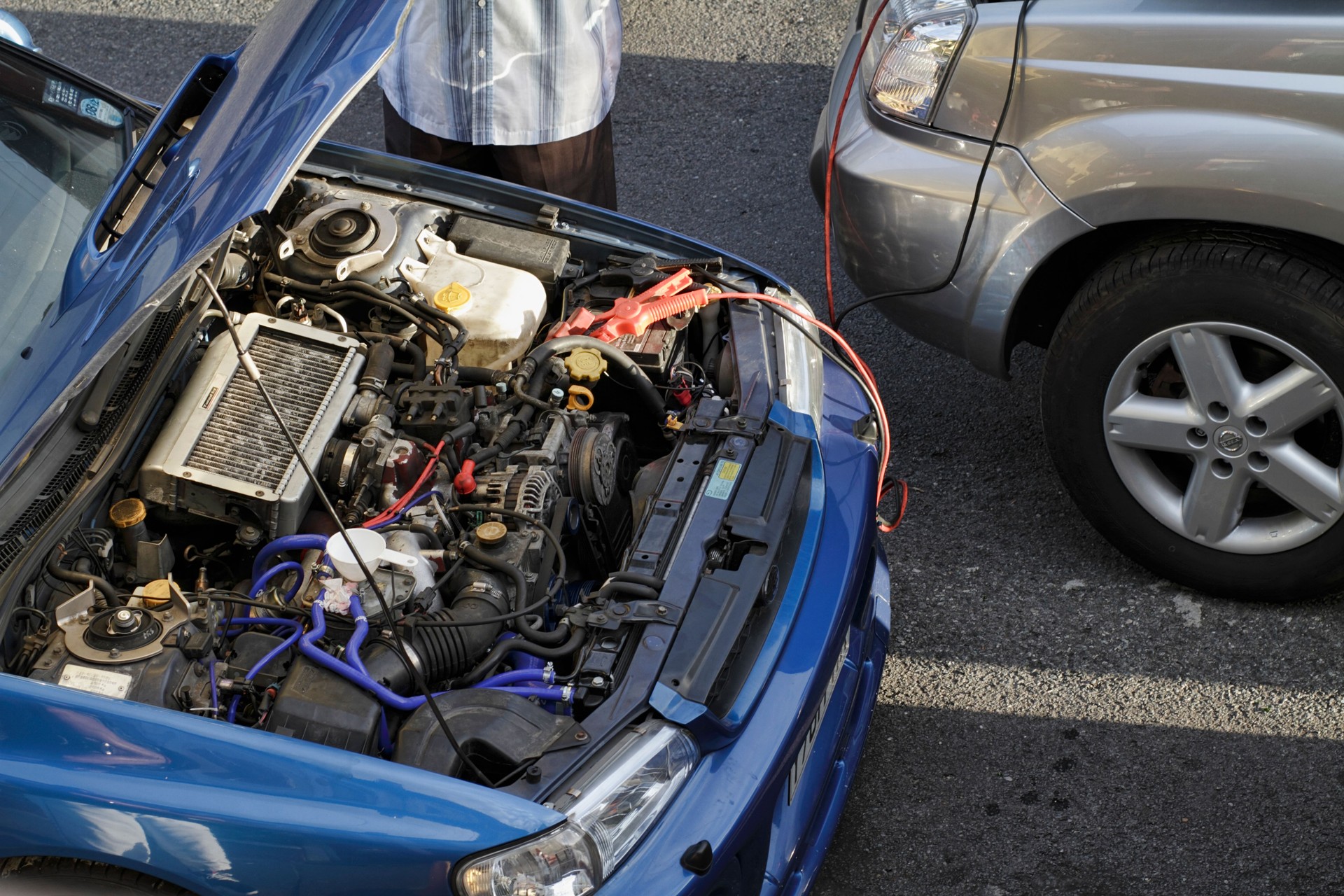Car engine jump start between two vehicles
